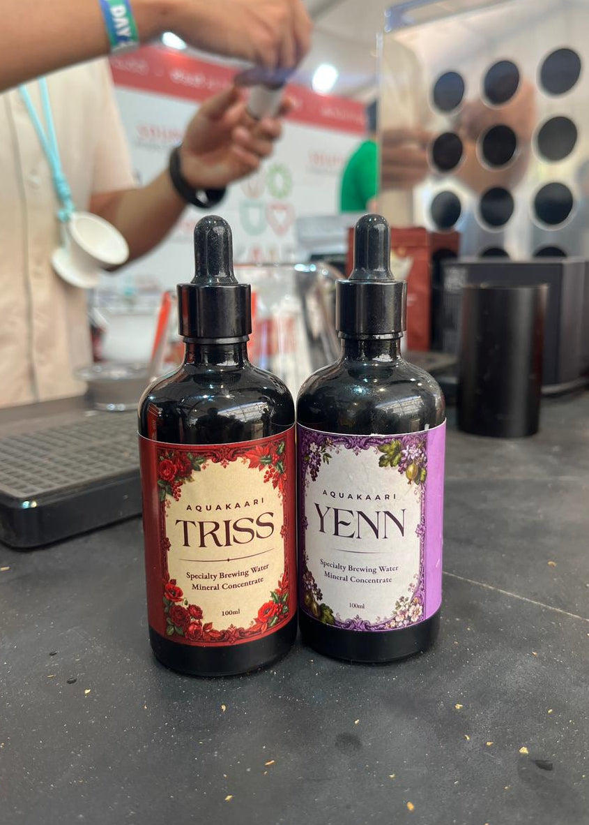 Two bottles labelled 'Triss' and 'Yenn' are on a counter with a blurred background.